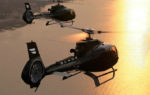blade helicopters over water sunset